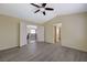 Spacious bedroom with wood-look flooring, vaulted ceiling, and open doors to the hallway at 3034 Scenic Valley Way, Henderson, NV 89052