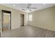 Bedroom with wood look floors and a fan, door to bathroom and closet at 3034 Scenic Valley Way, Henderson, NV 89052
