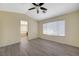 Open bedroom with light gray floors, vaulted ceilings, ceiling fan, and connecting bath at 3034 Scenic Valley Way, Henderson, NV 89052