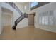 Bright foyer with a staircase and tiled floors, illuminated by natural light from a tall window at 3034 Scenic Valley Way, Henderson, NV 89052
