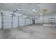 Spacious three-car garage with shelving for storage solutions at 3034 Scenic Valley Way, Henderson, NV 89052