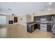 Open-concept kitchen featuring stainless steel appliances, granite countertops, and tile flooring at 3034 Scenic Valley Way, Henderson, NV 89052