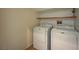 Laundry room featuring a white side-by-side washer and dryer and a wooden shelf overhead at 3034 Scenic Valley Way, Henderson, NV 89052