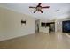 Expansive living area with tile floors, access to the kitchen, and a ceiling fan at 3034 Scenic Valley Way, Henderson, NV 89052
