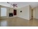 Living room with a fireplace, ceiling fan, tile floors, and ample natural light at 3034 Scenic Valley Way, Henderson, NV 89052