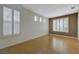 Light-filled living room with tile floors, white walls, and plantation shutters for a modern, clean look at 3034 Scenic Valley Way, Henderson, NV 89052