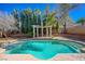 Refreshing pool with a tanning ledge and pergola; perfect for outdoor relaxation and entertaining at 3034 Scenic Valley Way, Henderson, NV 89052