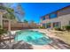 Backyard pool with a neutral colored home with sliding glass doors and a blue sky at 3034 Scenic Valley Way, Henderson, NV 89052