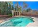 Backyard pool with a pergola and desert landscaping with a blue sky at 3034 Scenic Valley Way, Henderson, NV 89052
