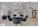 Inviting dining area with modern lighting, leading to the kitchen and living space at 3040 Hidden Treasure Dr, Las Vegas, NV 89134
