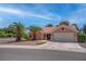 Beautiful single-story home with desert landscaping, large palm trees, and a two-car garage at 3040 Hidden Treasure Dr, Las Vegas, NV 89134