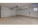 Spacious two-car garage with epoxy flooring, providing ample space for parking and storage at 3040 Hidden Treasure Dr, Las Vegas, NV 89134