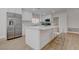 Spacious kitchen with an oversized island, stainless steel refrigerator, and modern white cabinets at 3040 Hidden Treasure Dr, Las Vegas, NV 89134