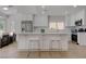 Bright kitchen features white cabinetry, stainless steel appliances, and a large center island with seating at 3040 Hidden Treasure Dr, Las Vegas, NV 89134