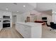 Open-concept kitchen with stainless steel appliances, white cabinetry, and a large island with seating at 3040 Hidden Treasure Dr, Las Vegas, NV 89134