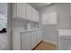 Laundry room featuring white cabinets and sink with an updated washer and dryer at 3040 Hidden Treasure Dr, Las Vegas, NV 89134