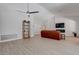 Open-concept living room featuring hardwood floors, a modern fireplace, and large windows for natural light at 3040 Hidden Treasure Dr, Las Vegas, NV 89134