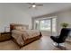 Comfortable main bedroom with a wood bed frame, lots of natural light and a ceiling fan at 3040 Hidden Treasure Dr, Las Vegas, NV 89134