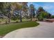 Expansive backyard with lush green grass, mature trees, and well-maintained landscaping at 3040 Hidden Treasure Dr, Las Vegas, NV 89134