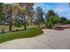 Lush backyard with mature trees, manicured landscaping, and a beautifully designed patio space at 3040 Hidden Treasure Dr, Las Vegas, NV 89134