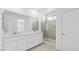Bright bathroom with double vanity, quartz counters, and a glass-enclosed shower at 328 Taylor St, Henderson, NV 89015