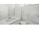 A clean bathroom with a walk-in shower with glass doors, a white vanity, and chrome fixtures at 328 Taylor St, Henderson, NV 89015