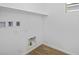 Laundry room with wood-look tile floors, utility hookups, and a window for natural light at 328 Taylor St, Henderson, NV 89015