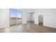 Bright living room featuring wood-look tile floors, balcony access, and ensuite bathroom at 328 Taylor St, Henderson, NV 89015