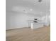 Open-concept living room with wood-look tile floors, modern kitchen, and ample space for entertaining at 328 Taylor St, Henderson, NV 89015