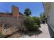 Spacious backyard area with mature plants and concrete block wall offers privacy and space for outdoor activities at 3382 Berwyck St, Las Vegas, NV 89121