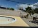 The backyard has an empty pool, a beige patio area, and a wall with trees nearby at 3382 Berwyck St, Las Vegas, NV 89121