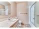 Bathroom features a tub/shower combo with glass doors, single sink vanity, and marble-look countertops at 3382 Berwyck St, Las Vegas, NV 89121