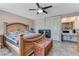 Spacious bedroom featuring a large bed, ceiling fan, and en-suite bathroom with vanity at 3382 Berwyck St, Las Vegas, NV 89121