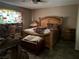 Bedroom with stained glass window features a wooden bed frame and matching wooden night stands at 3382 Berwyck St, Las Vegas, NV 89121