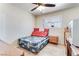 Bedroom features a ceiling fan, window with horizontal blinds, and a bed with floral pattern bedding at 3382 Berwyck St, Las Vegas, NV 89121