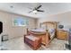 Bright bedroom with large bed, ceiling fan, chest, and bright natural light from a window at 3382 Berwyck St, Las Vegas, NV 89121