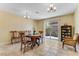 Bright dining area featuring a chandelier and sliding door to the backyard at 3382 Berwyck St, Las Vegas, NV 89121