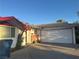 Charming single-story home featuring a two-car garage and a brick accent wall near the front entrance at 3382 Berwyck St, Las Vegas, NV 89121