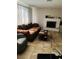 Cozy living room featuring a decorative fireplace, tile flooring, and natural light at 3382 Berwyck St, Las Vegas, NV 89121