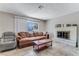 Bright and inviting living room with a fireplace, tile floors, and neutral decor at 3382 Berwyck St, Las Vegas, NV 89121