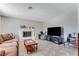 Bright and inviting living room with a fireplace, tile floors, and neutral decor at 3382 Berwyck St, Las Vegas, NV 89121