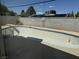 Backyard features an empty in-ground pool, patio and tall brick wall, great for enjoying sunny days at 3382 Berwyck St, Las Vegas, NV 89121