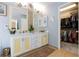 Bathroom features double sinks, white cabinets, and a walk-in closet at 3404 Brayton Mist Dr, North Las Vegas, NV 89081