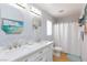 Bathroom featuring dual sinks, bright vanity lighting, and a shower with tub at 3404 Brayton Mist Dr, North Las Vegas, NV 89081