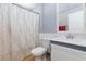 Bathroom featuring a shower with patterned curtain, a toilet, and a sink with a white cabinet base at 3404 Brayton Mist Dr, North Las Vegas, NV 89081
