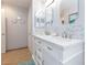 Bathroom showcasing double sinks, ample counter space and white cabinets at 3404 Brayton Mist Dr, North Las Vegas, NV 89081
