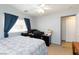 Bedroom featuring carpet flooring, a ceiling fan, a window with curtains, and a desk with monitors at 3404 Brayton Mist Dr, North Las Vegas, NV 89081