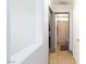 Hallway leading to bathroom with neutral tile flooring and modern white door, showcasing the home's functional layout at 3404 Brayton Mist Dr, North Las Vegas, NV 89081