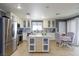 Spacious kitchen with stainless steel appliances, custom island, and cozy breakfast nook at 3404 Brayton Mist Dr, North Las Vegas, NV 89081