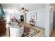Inviting living room featuring tile floors, ceiling fan, dining table and chairs, and cozy seating area with floral armchairs at 3404 Brayton Mist Dr, North Las Vegas, NV 89081